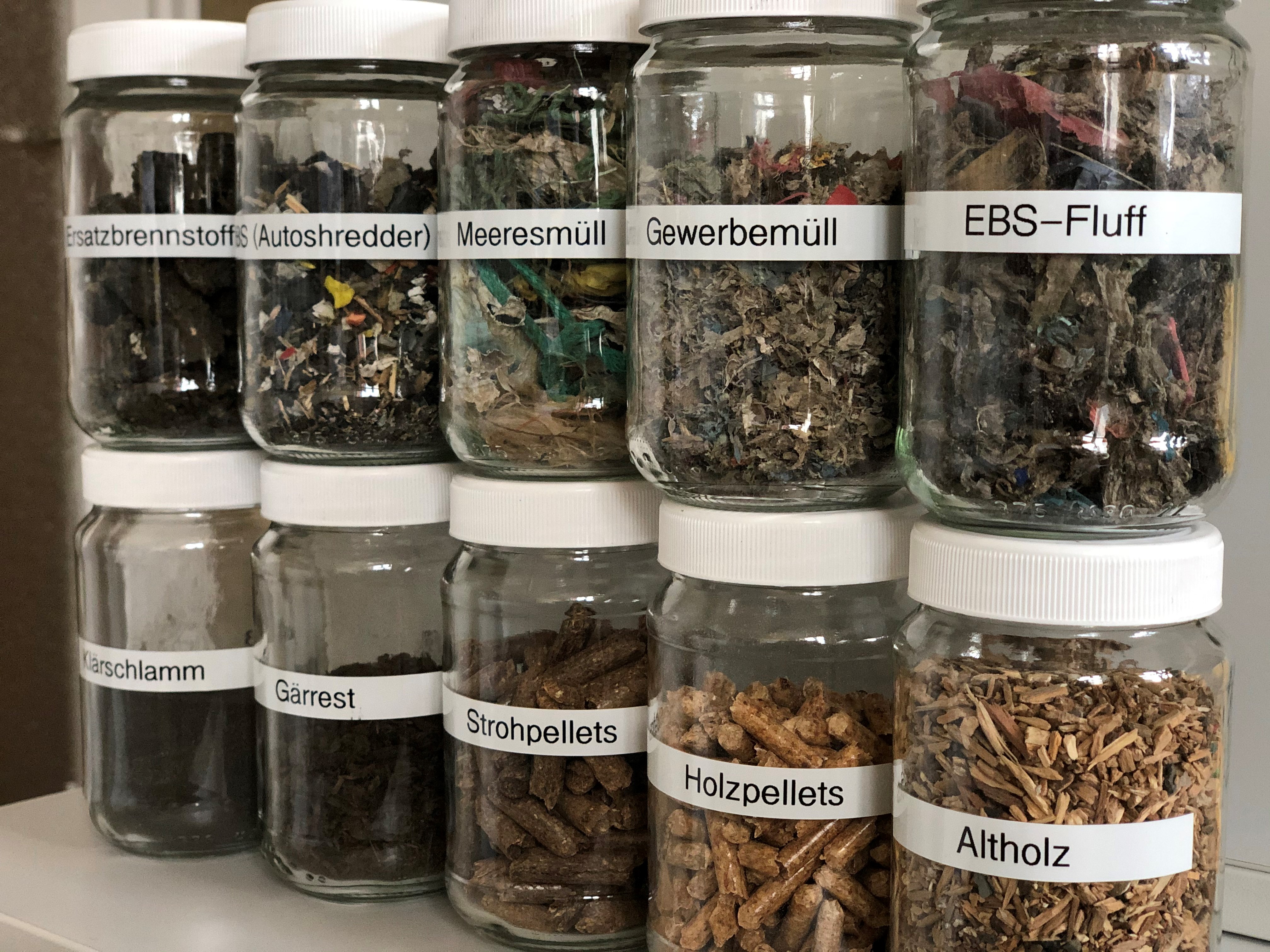 Mögliche Einsatzstoffe für chemisches Recycling Mögliche Einsatzstoffe für chemisches Recycling in Gläsern übereinander gestapelt (z.B. Meeresmüll, Altholz oder Gewerbemüll)